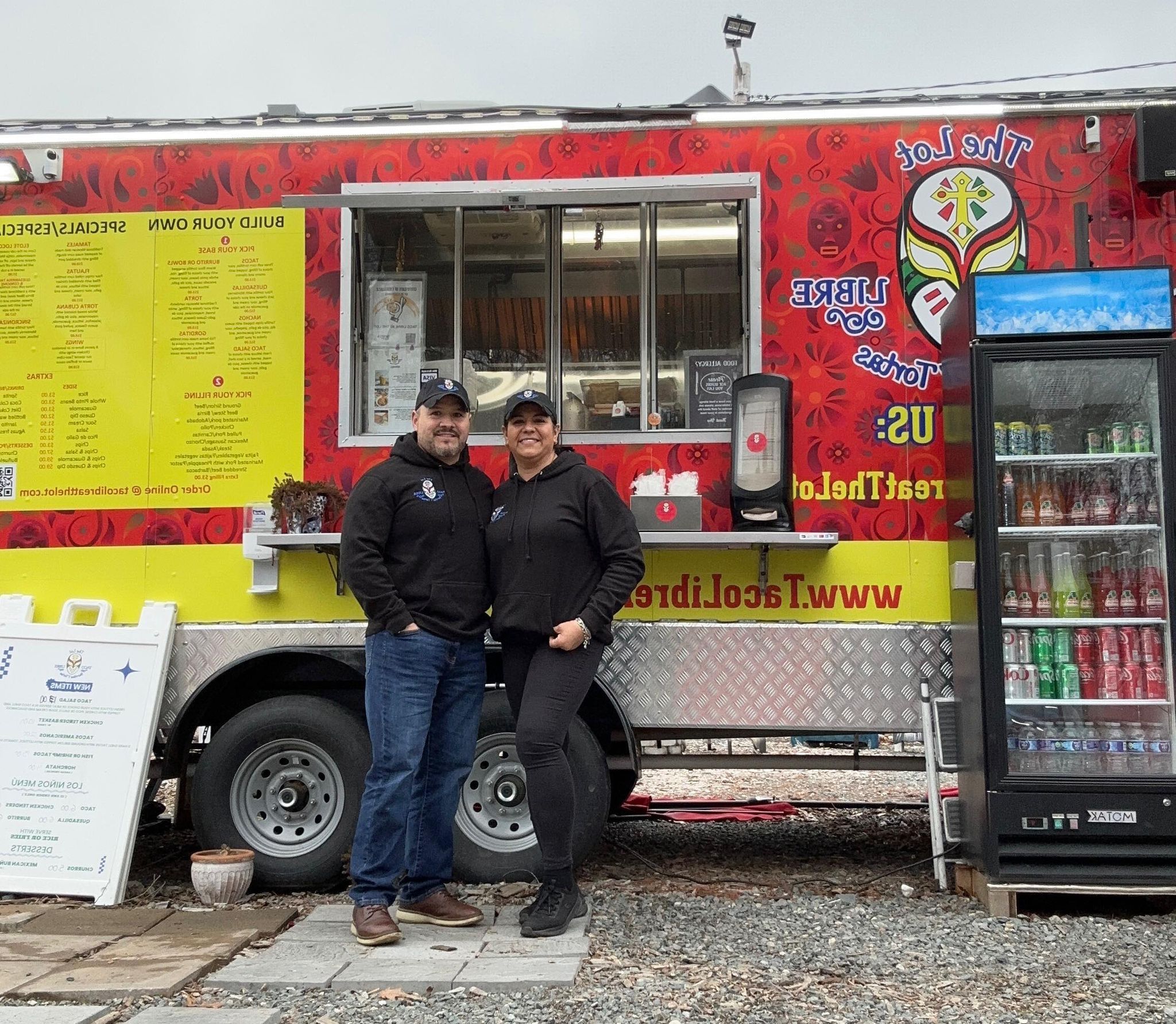 Mayra and Jaime the owners of Taco Libre standing in front of their food truck.