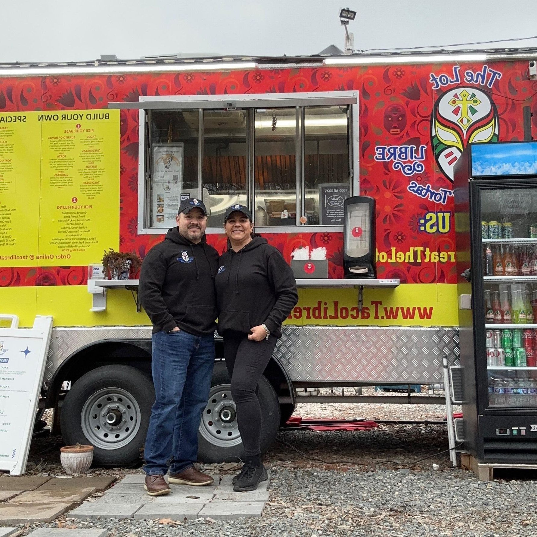Mayra and Jaime the owners of Taco Libre standing in front of their food truck.